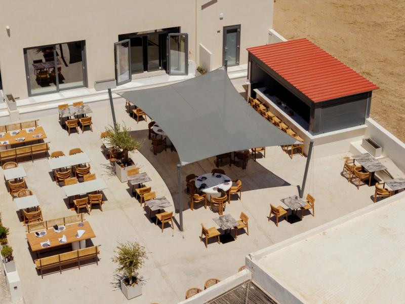 Outdoor dining terrace at Armia Experience Hotel, Vári, Sýros
